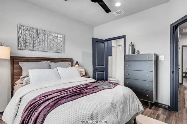 a bedroom with a bed and wooden floor