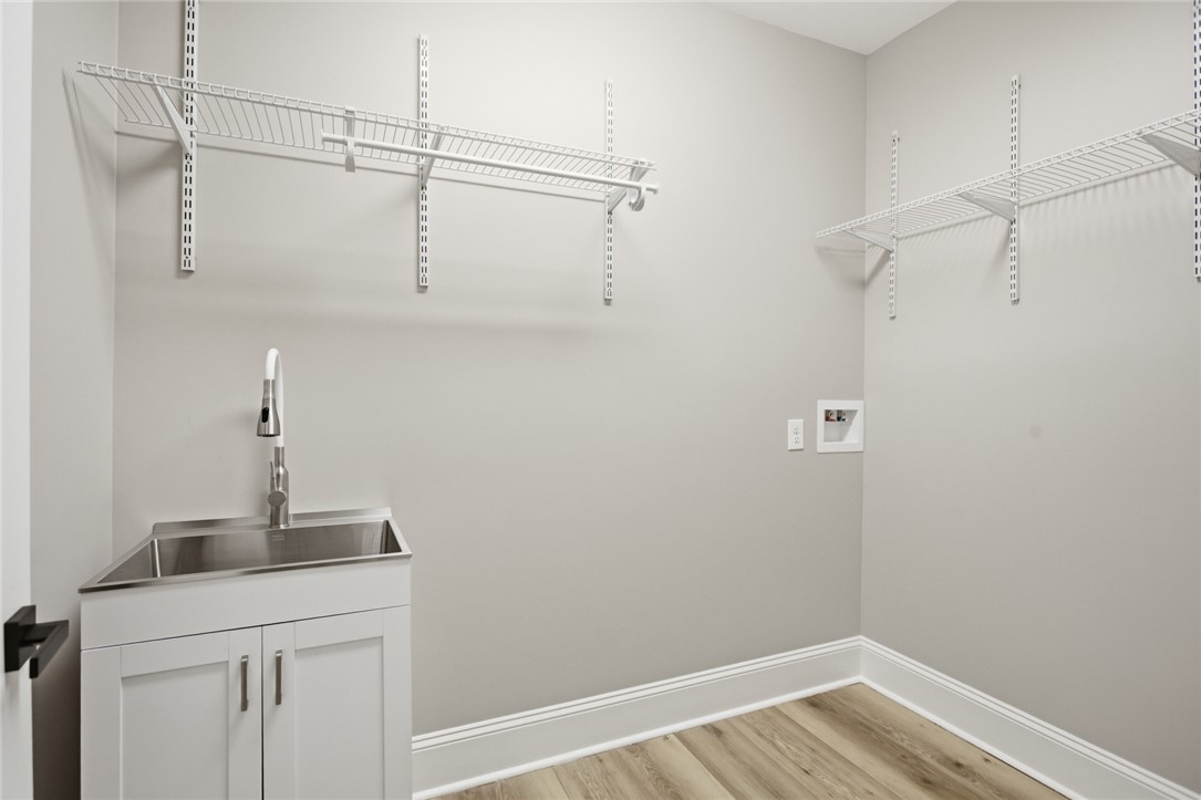 147 McAlister Road West Union, SC 29696 - Photo 19 of 49 Functional laundry room with ample storage and a convenient sink for household tasks.