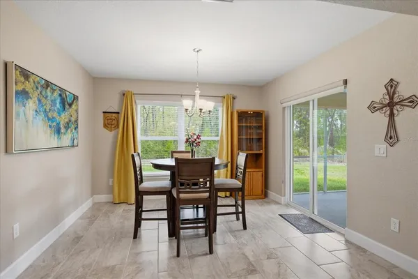 a view of a dining room with furniture window and outside view