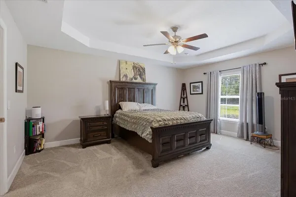 a room with a bed dresser and a window