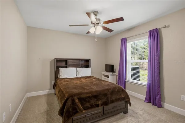a bedroom with a bed and window
