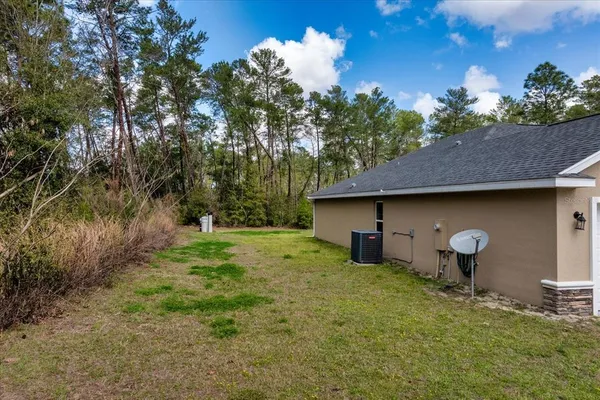 a backyard of a house with table and chairs