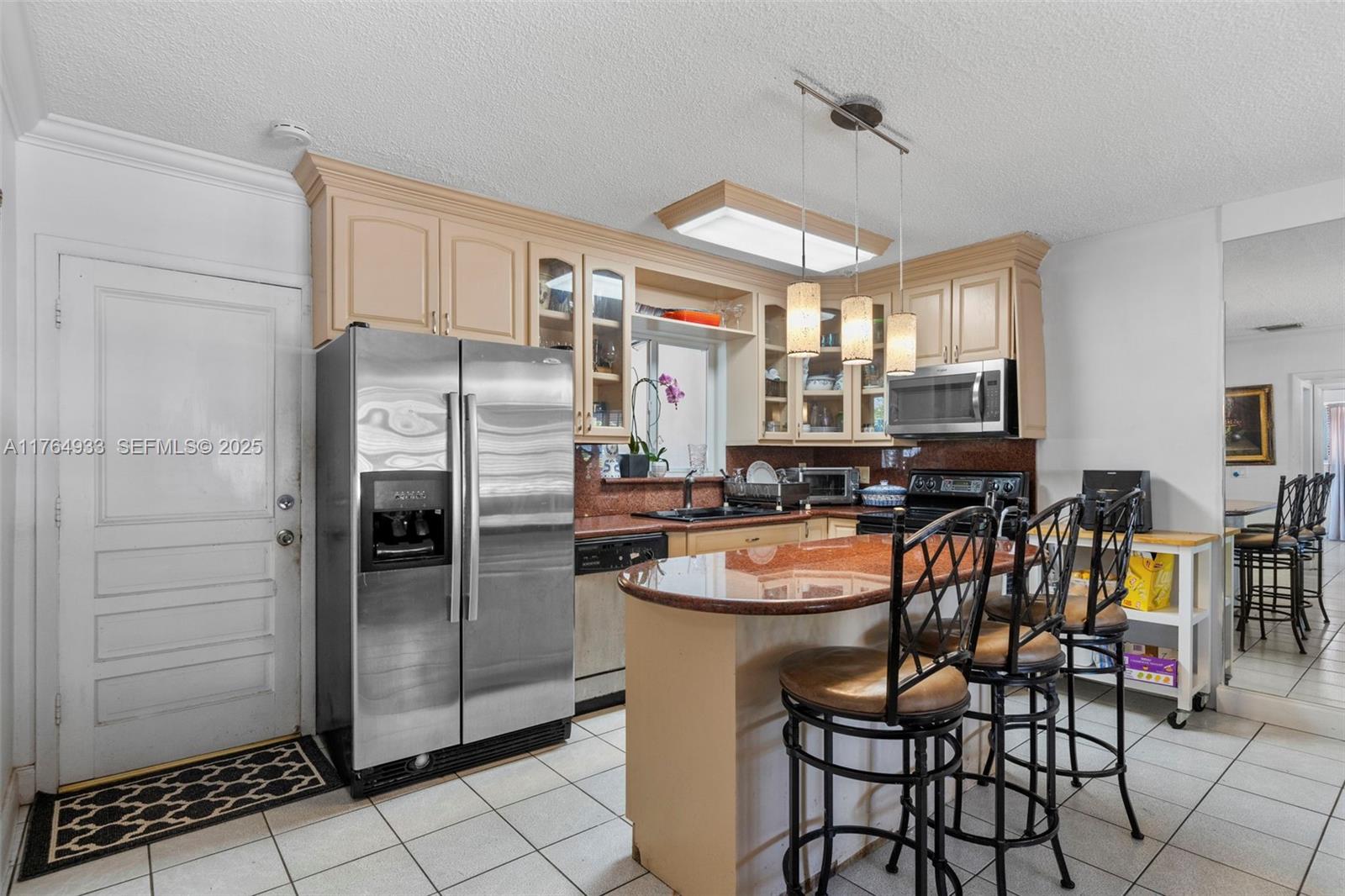 5810 Southwest 22nd Street Miami, FL 33155 - Photo 11 of 54 a kitchen with stainless steel appliances granite countertop a refrigerator a stove a sink and dishwasher a oven with white cabinets