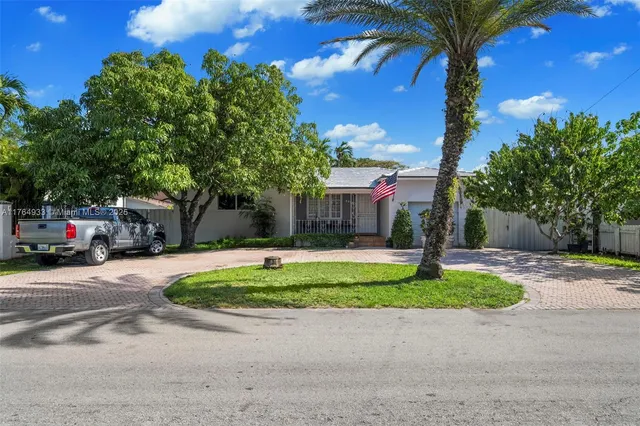 an aerial view of a house with a yard and a lot of lake