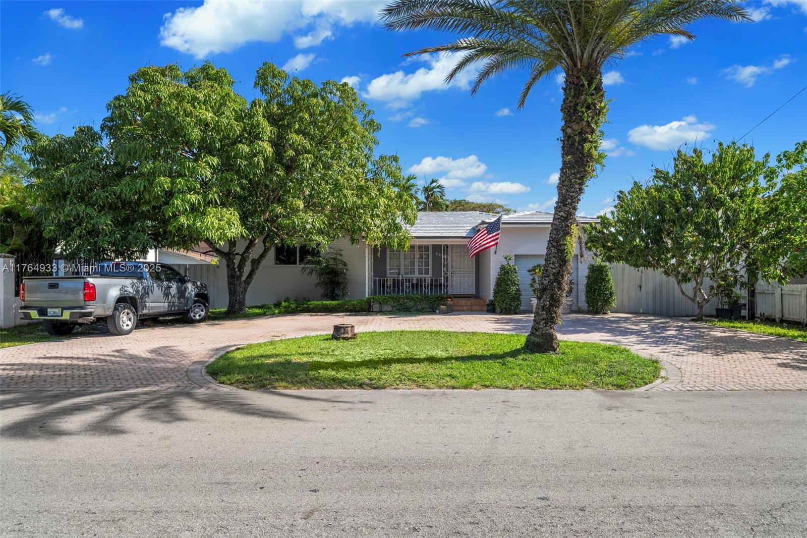 5810 Southwest 22nd Street Miami, FL 33155 - Photo 3 of 54 a front view of a house with a yard and a garage
