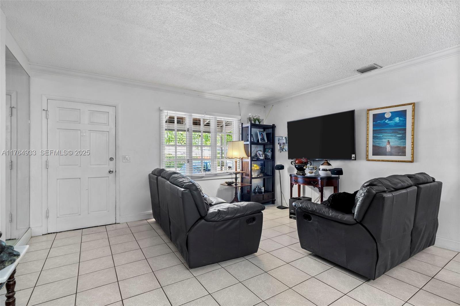 5810 Southwest 22nd Street Miami, FL 33155 - Photo 6 of 54 a living room with furniture and a flat screen tv
