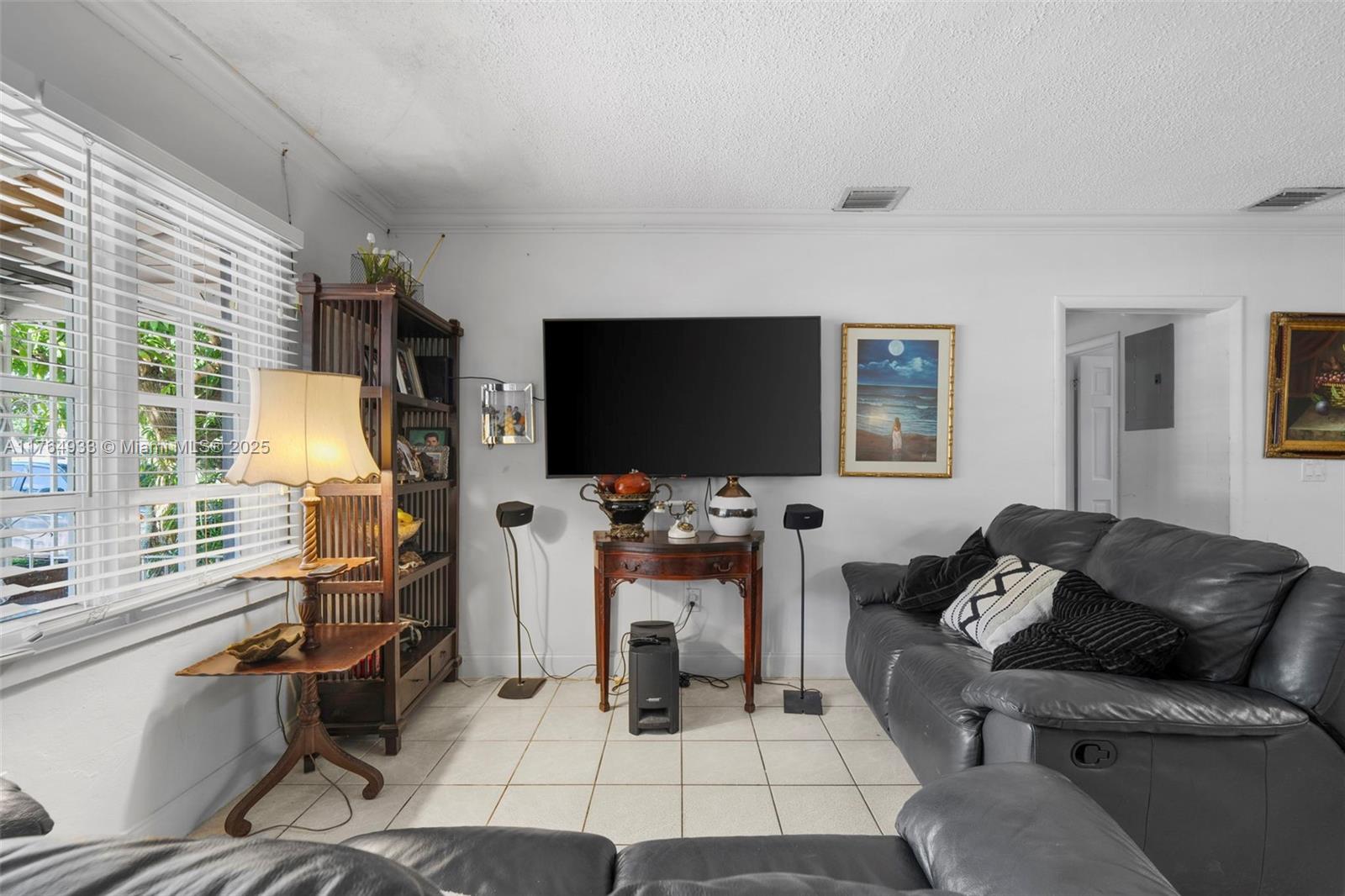 5810 Southwest 22nd Street Miami, FL 33155 - Photo 8 of 54 a living room with furniture a flat screen tv and a floor to ceiling window