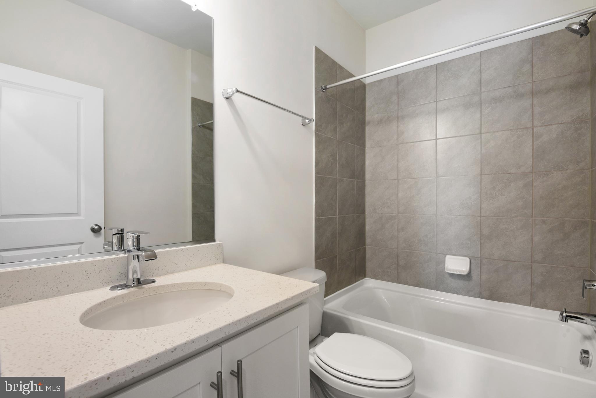 342 Ensemble Way Frederick, MD 21701 - Photo 16 of 25 a bathroom with a bathtub sink vanity mirror and toilet
