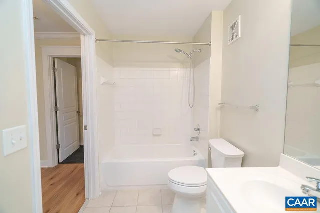 a bathroom with a shower a bathtub and toilet