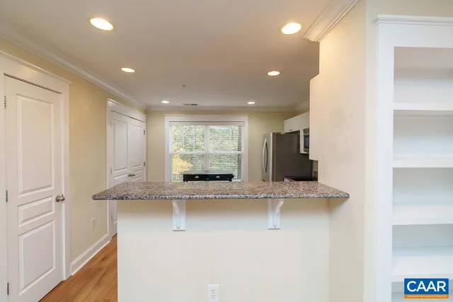 a view of counter top space with granite countertop stainless steel appliances
