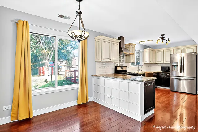 a view of a hallway with wooden floor and closet area