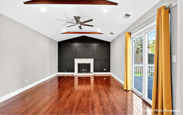 a view of wooden floor and windows in a room