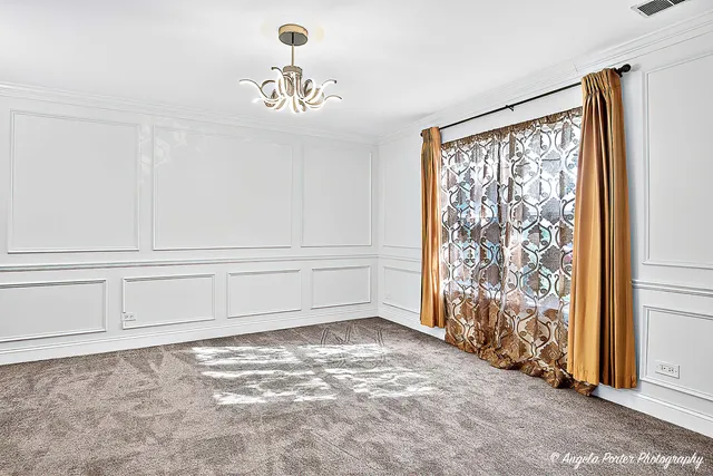 a view of a hallway with wooden floor and a kitchen
