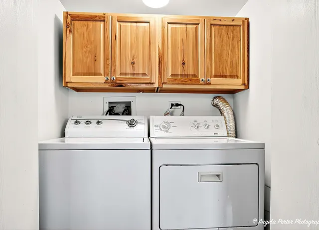 a kitchen with stainless steel appliances granite countertop a refrigerator a stove a sink and white cabinets with wooden floors