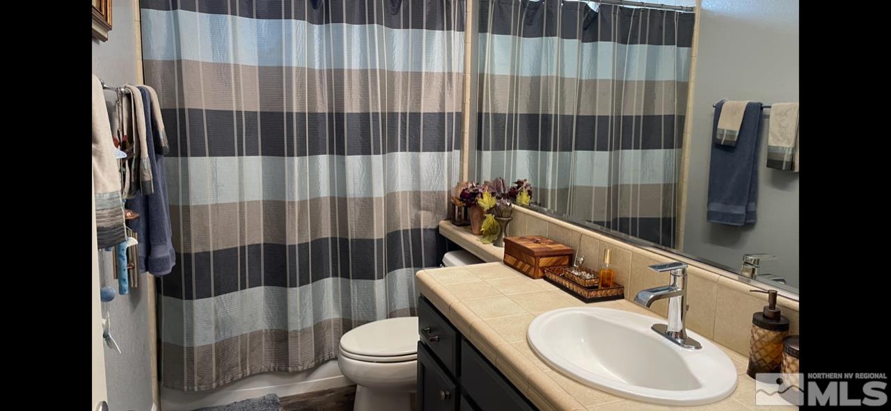 10635 Fire Poppy Circle Reno, NV 89521 - Photo 23 of 33 a bathroom with a sink toilet and shower