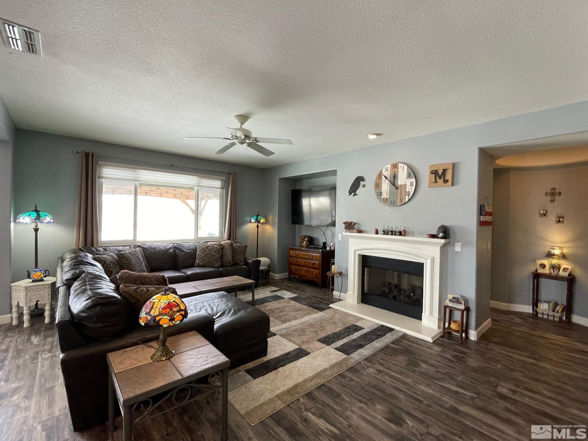 10635 Fire Poppy Circle Reno, NV 89521 - Photo 4 of 33 a living room with furniture fireplace and a window