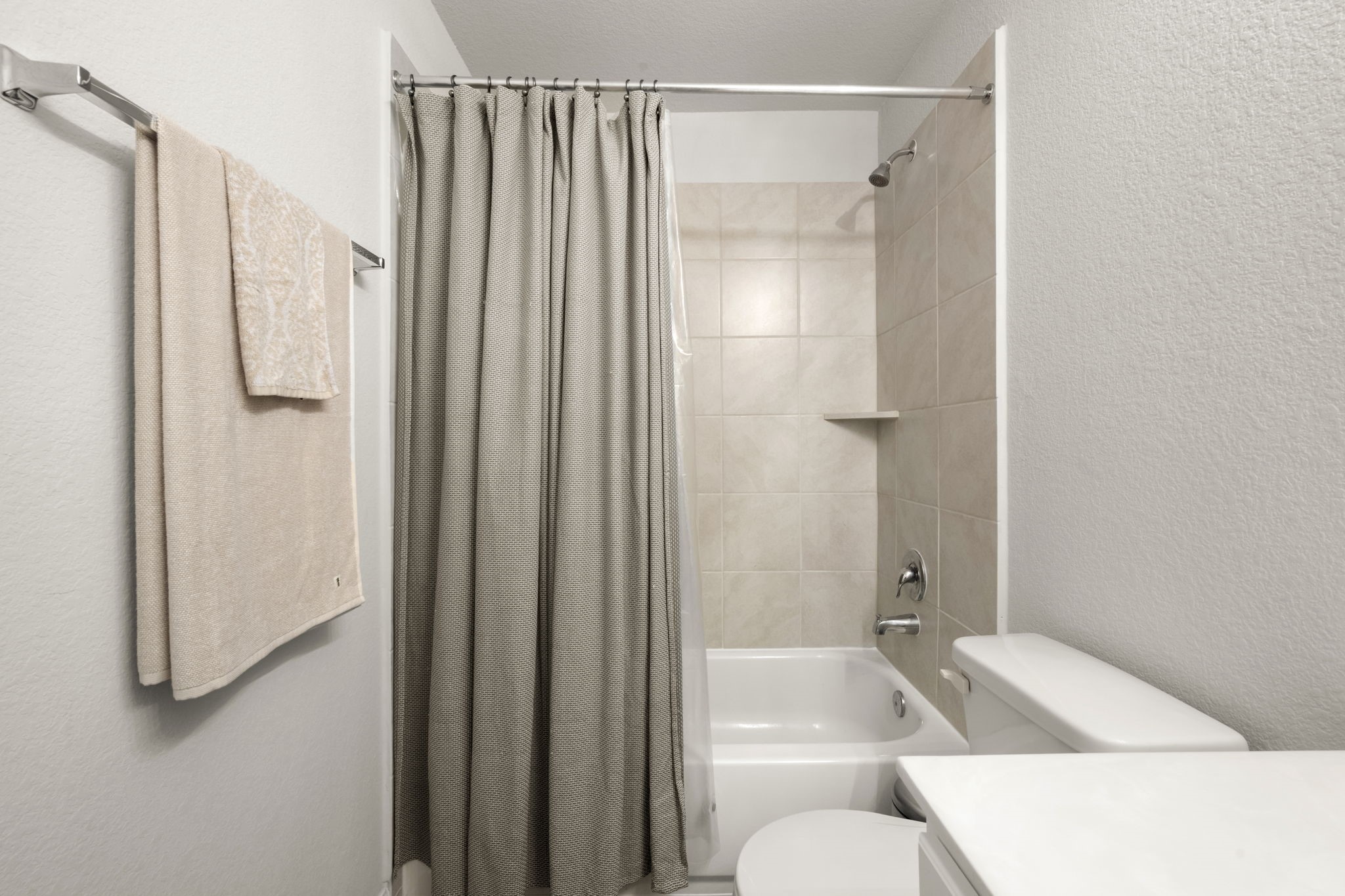 4915 Blue Jacaranda Way Spring, TX 77373 - Photo 25 of 30 Appreciate the pretty and neutral tile bath surround rather than a plastic shower wall.