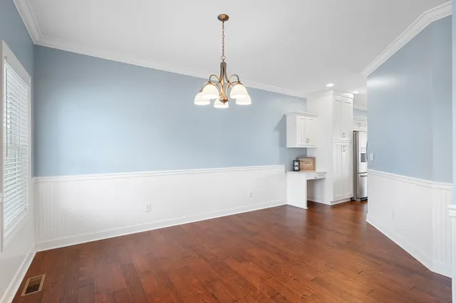 a view of a room with wooden floor and a window