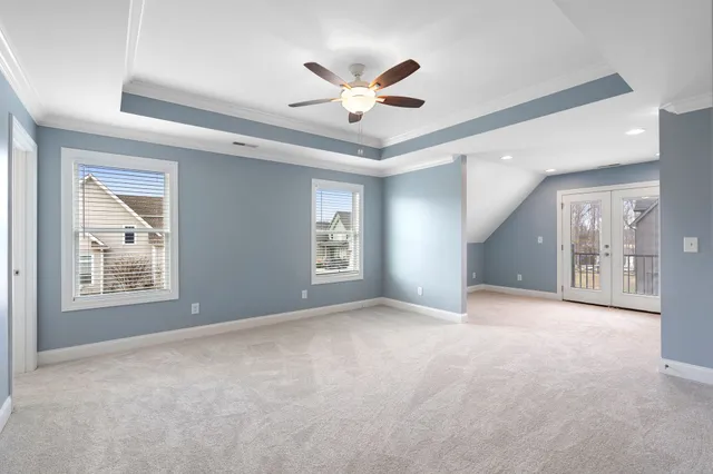 a view of a livingroom with a ceiling fan and window