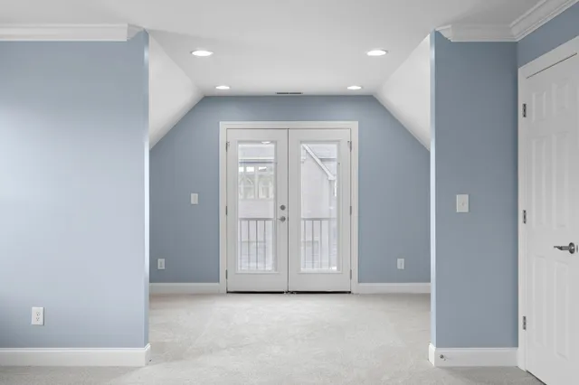 an empty room with windows and closet