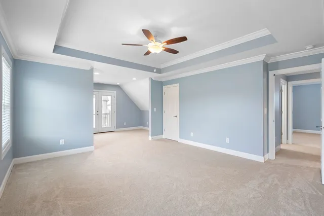 a view of an empty room with a ceiling fan