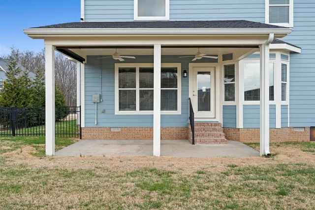 a view of a house with backyard sitting area and garden