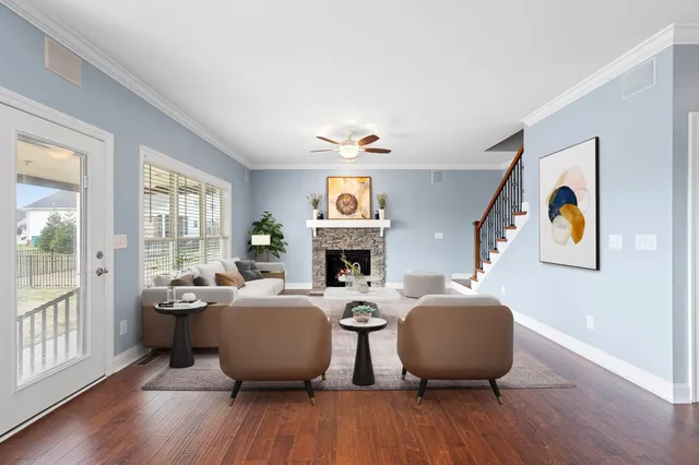 a living room with fireplace furniture and a wooden floor
