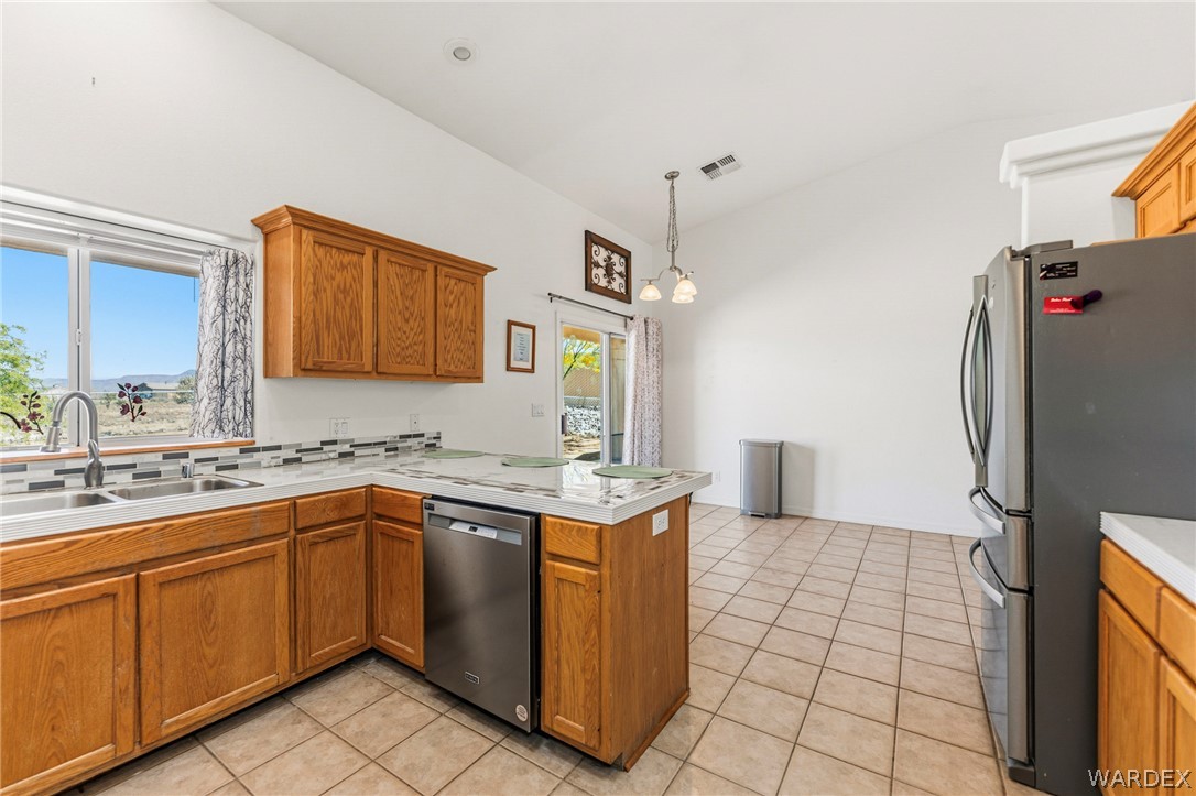 9332 Branded Road Kingman, AZ 86401 - Photo 10 of 44 a kitchen with stainless steel appliances granite countertop a sink and a refrigerator