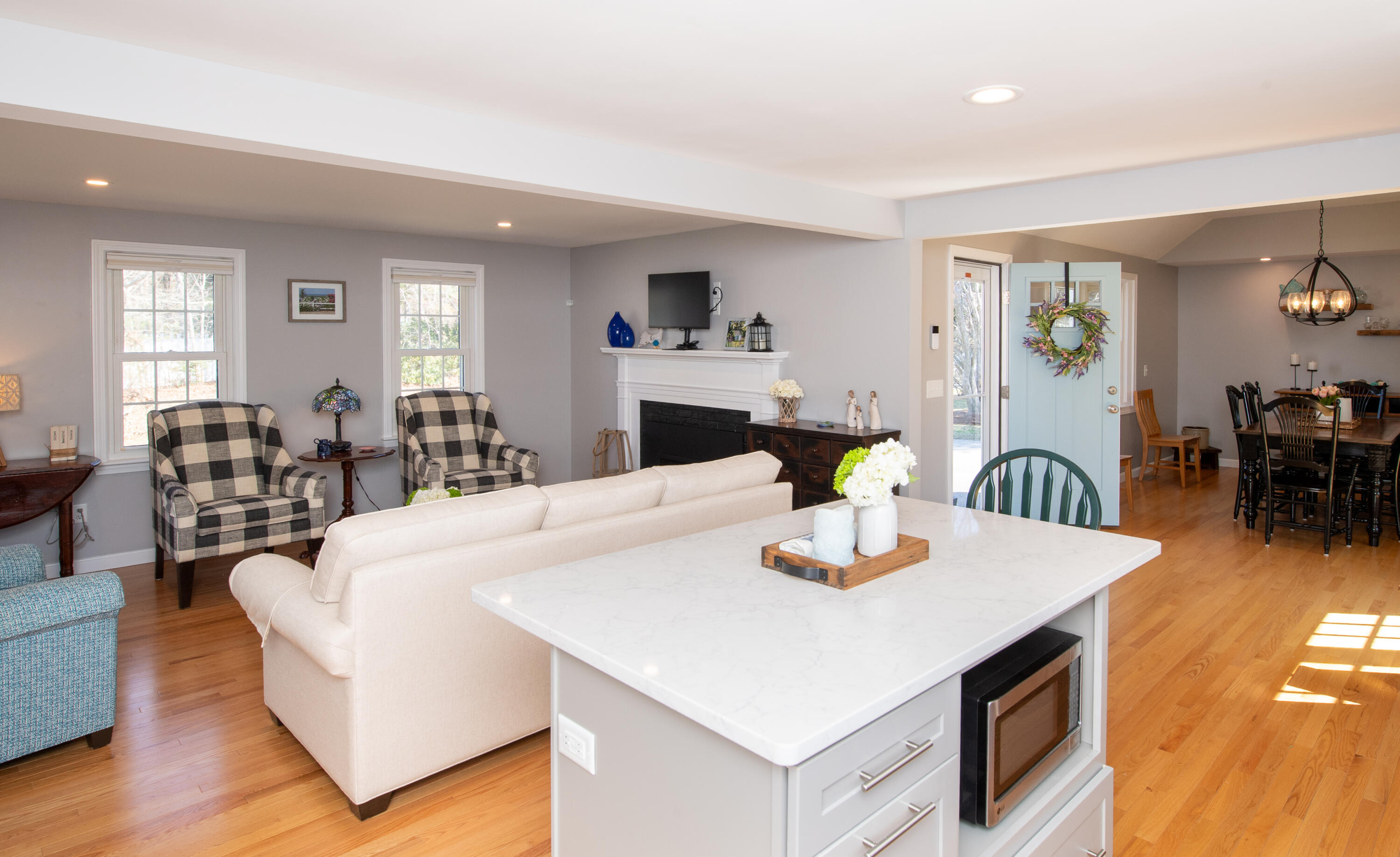 89 Trout Brook Road Cotuit, MA 02635 - Photo 11 of 67 a living room with dining table and wooden floor
