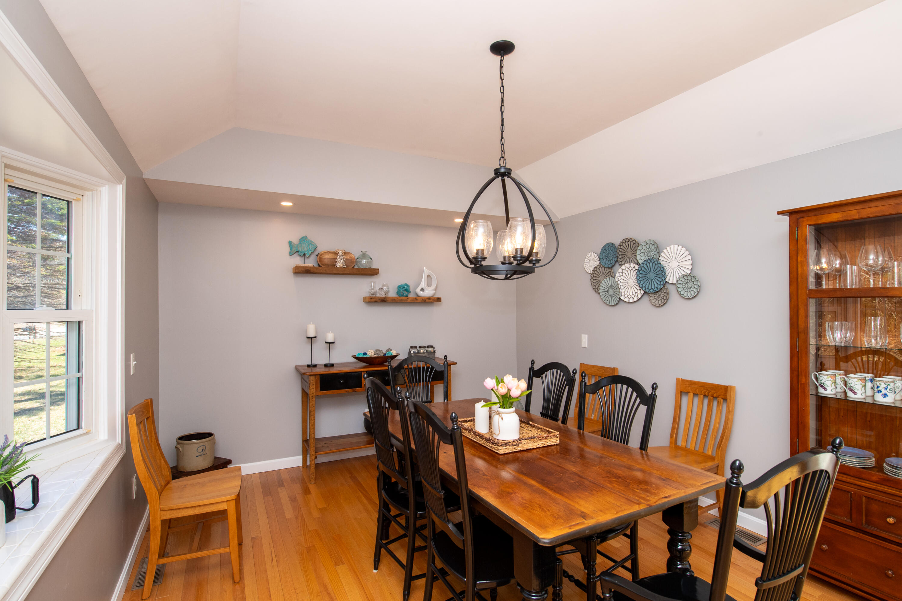 89 Trout Brook Road Cotuit, MA 02635 - Photo 13 of 67 a view of a dining room with furniture a chandelier and wooden floor