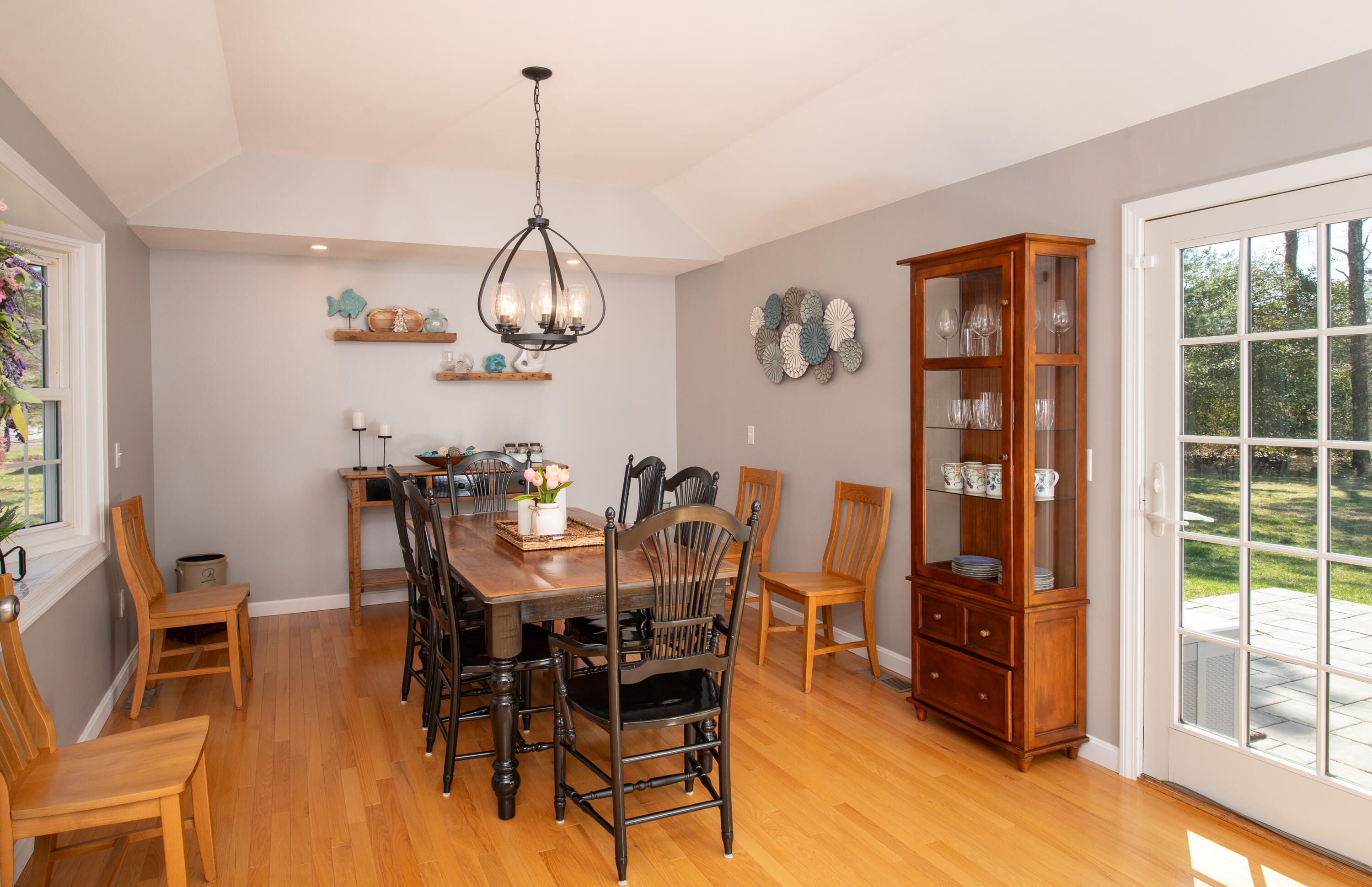 89 Trout Brook Road Cotuit, MA 02635 - Photo 16 of 67 a view of a dining room a livingroom with furniture wooden floor a rug and a chandelier