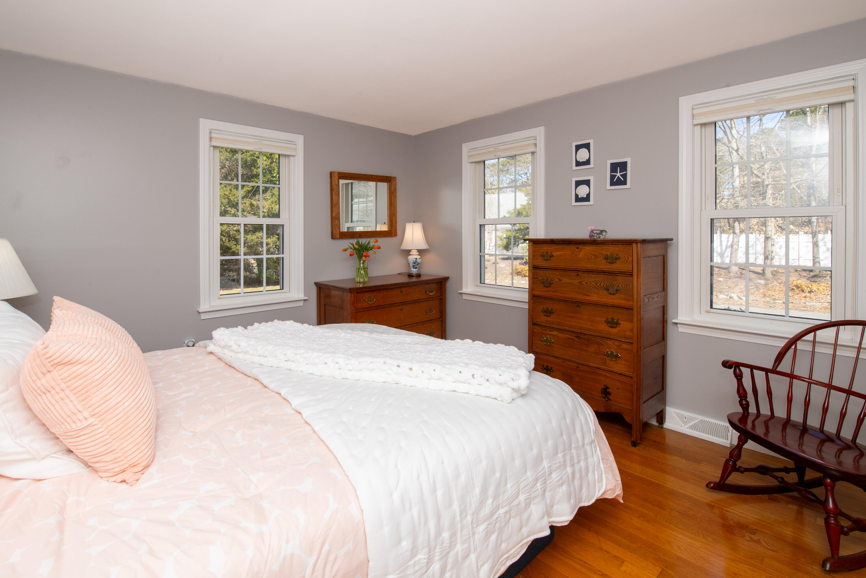 89 Trout Brook Road Cotuit, MA 02635 - Photo 17 of 67 a bedroom with a bed and wooden floor