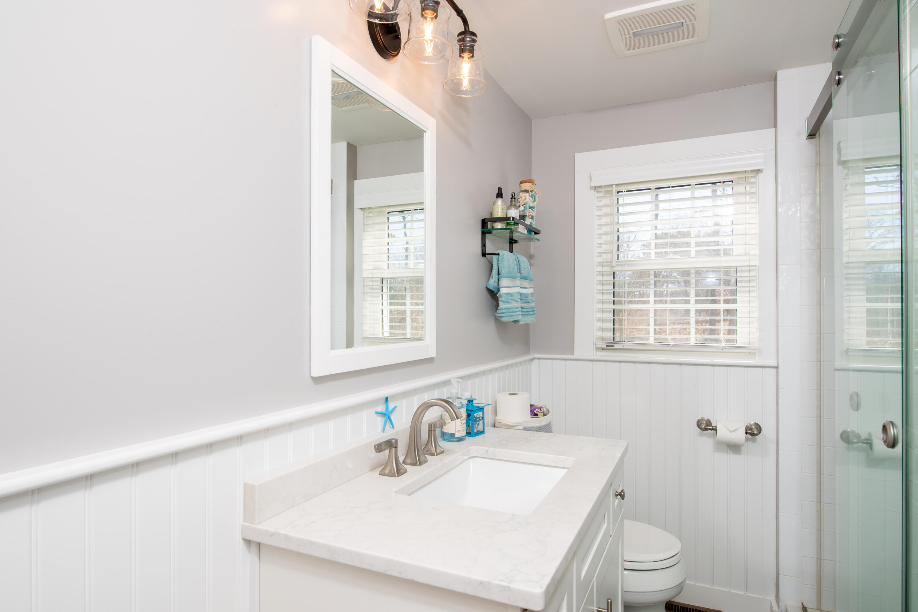 89 Trout Brook Road Cotuit, MA 02635 - Photo 21 of 67 a bathroom with a sink a toilet and a window