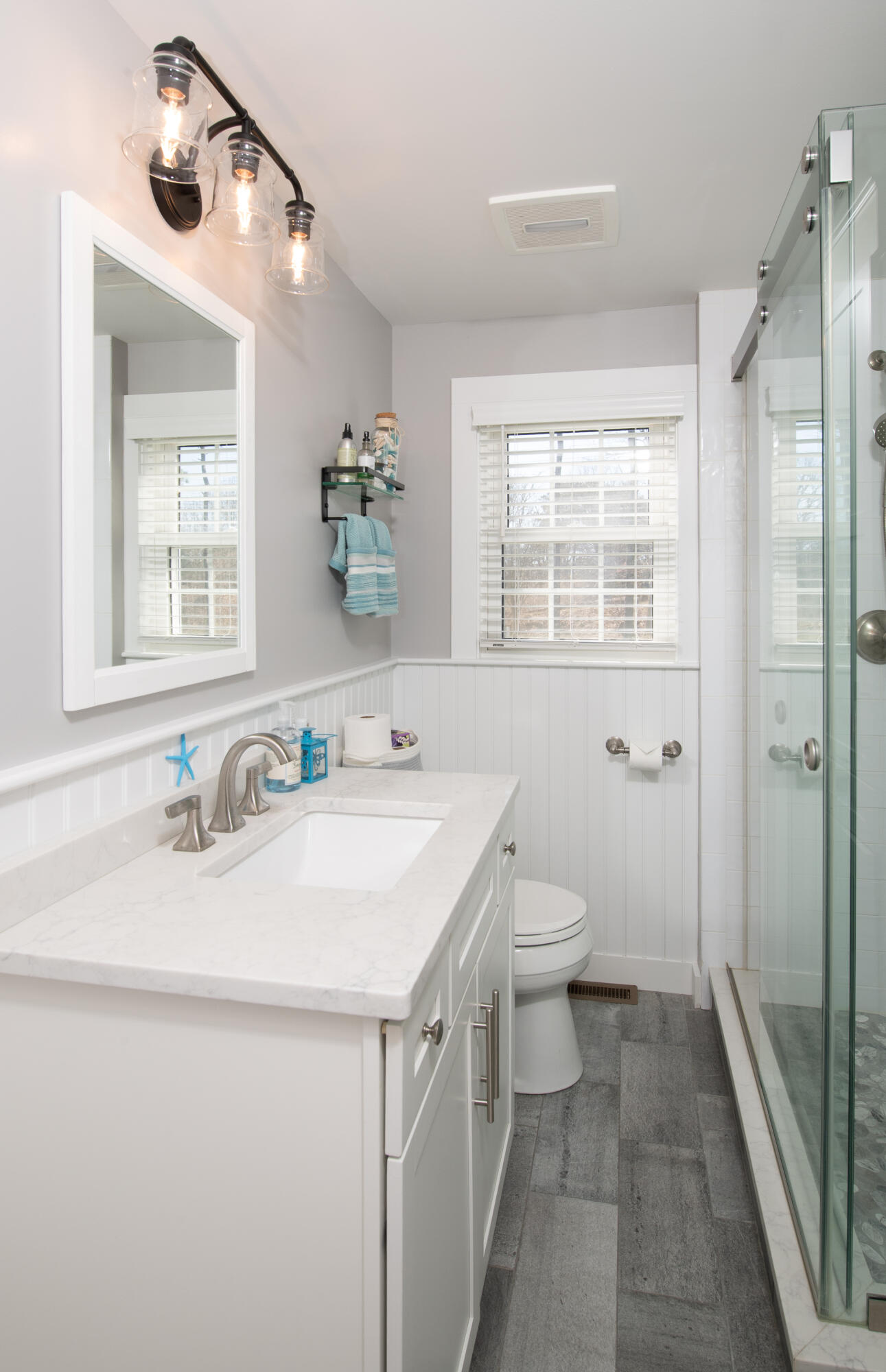 89 Trout Brook Road Cotuit, MA 02635 - Photo 22 of 67 a bathroom with a granite countertop sink a toilet and a mirror