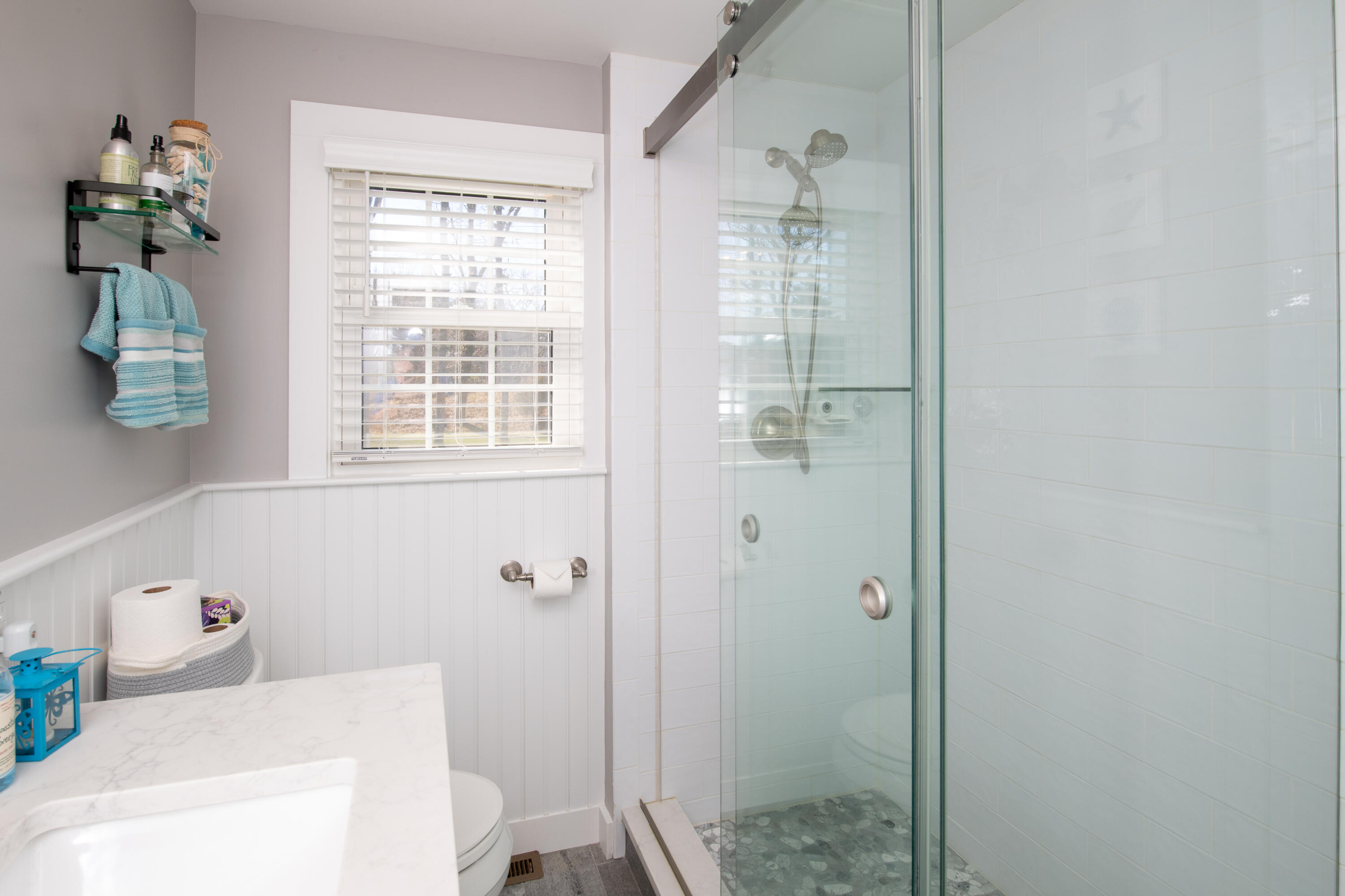 89 Trout Brook Road Cotuit, MA 02635 - Photo 23 of 67 a bathroom with a tub shower and window