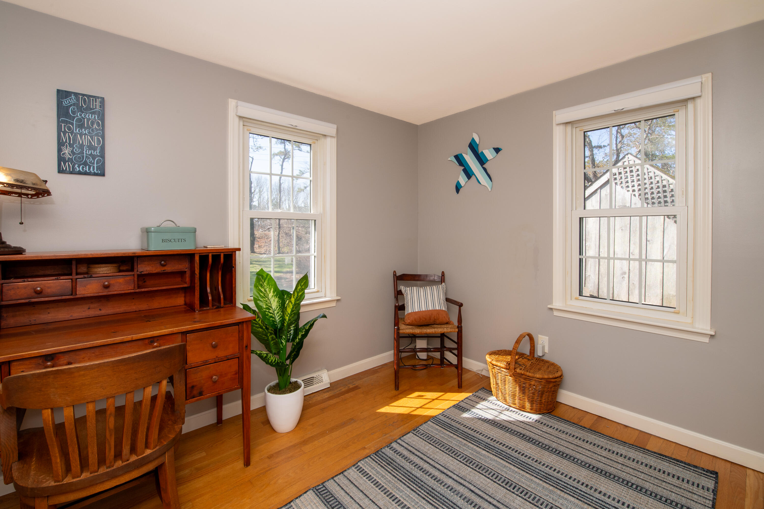 89 Trout Brook Road Cotuit, MA 02635 - Photo 25 of 67 a living room with wooden floor and a potted plant