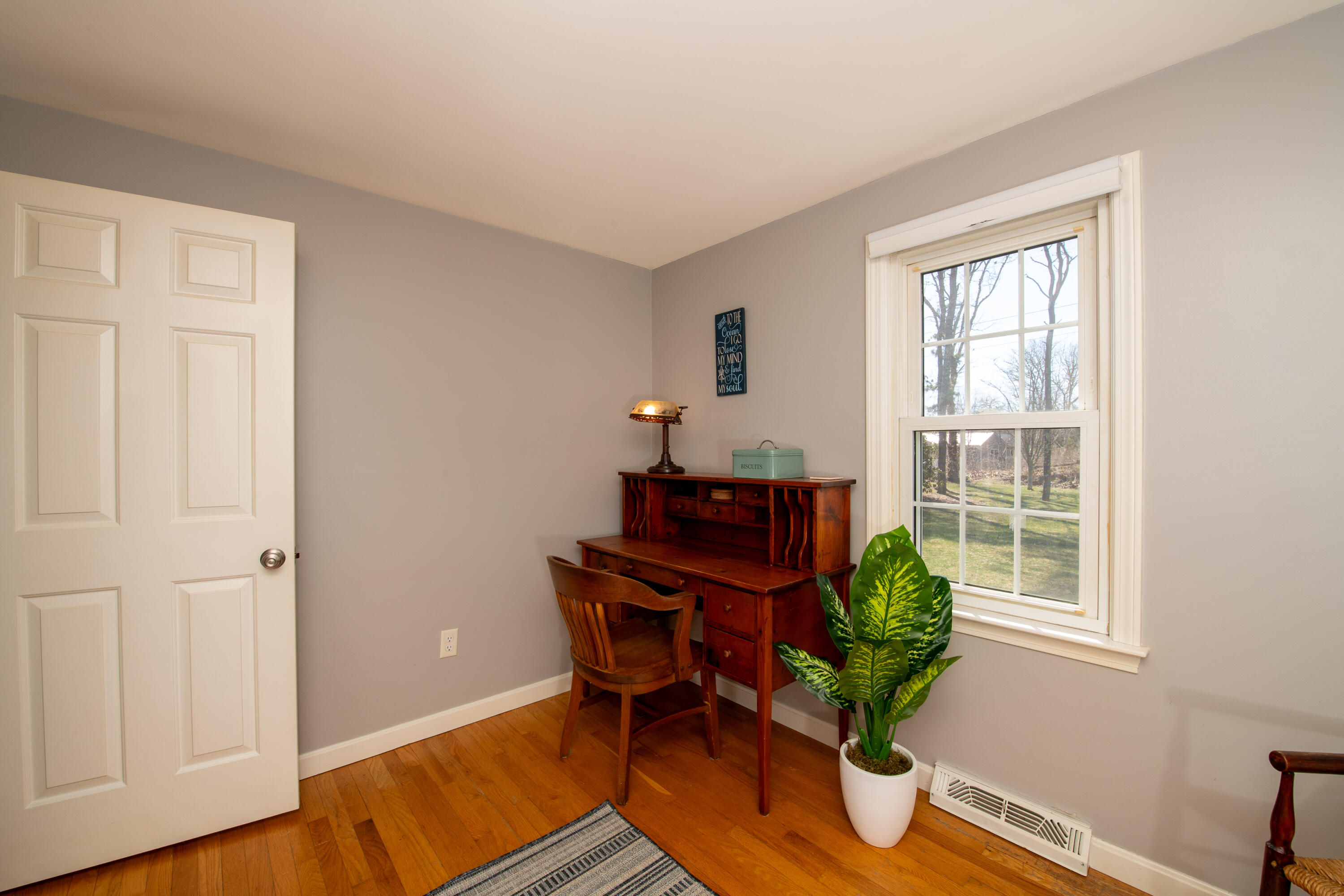 89 Trout Brook Road Cotuit, MA 02635 - Photo 26 of 67 a living room with furniture a window and a potted plant