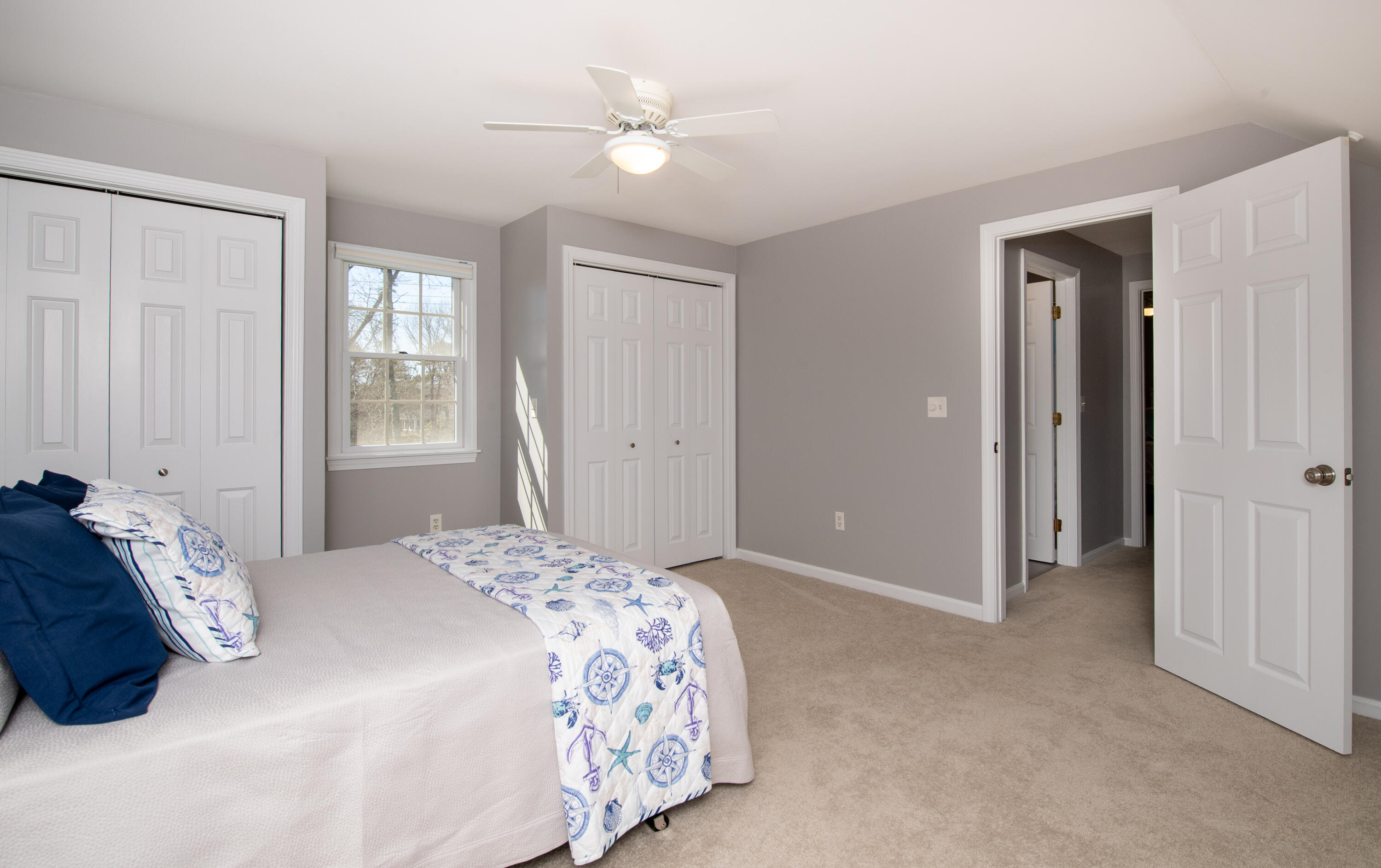 89 Trout Brook Road Cotuit, MA 02635 - Photo 31 of 67 a bedroom with a bed closet and a window