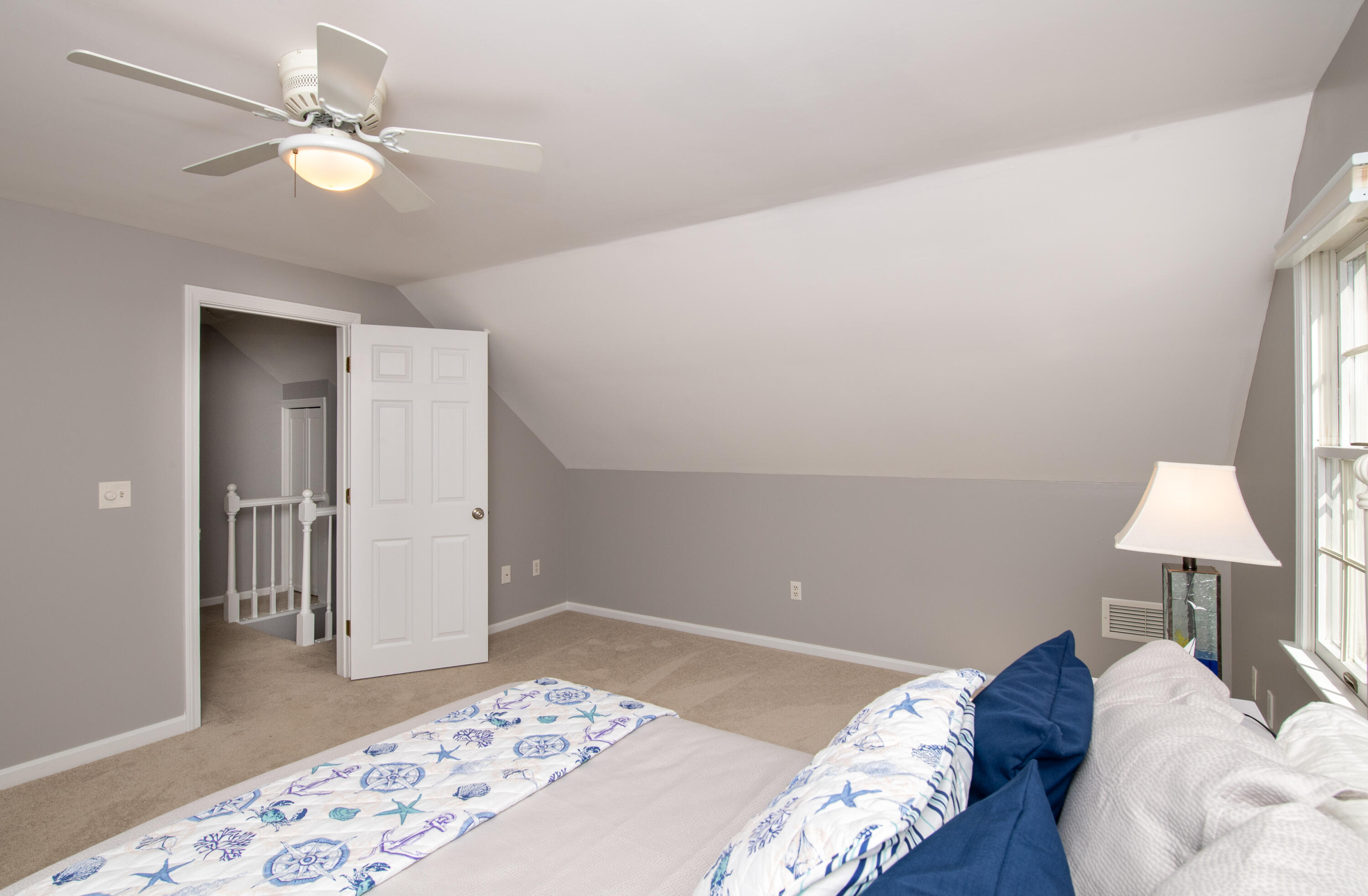 89 Trout Brook Road Cotuit, MA 02635 - Photo 32 of 67 a bedroom with a bed and a lamp