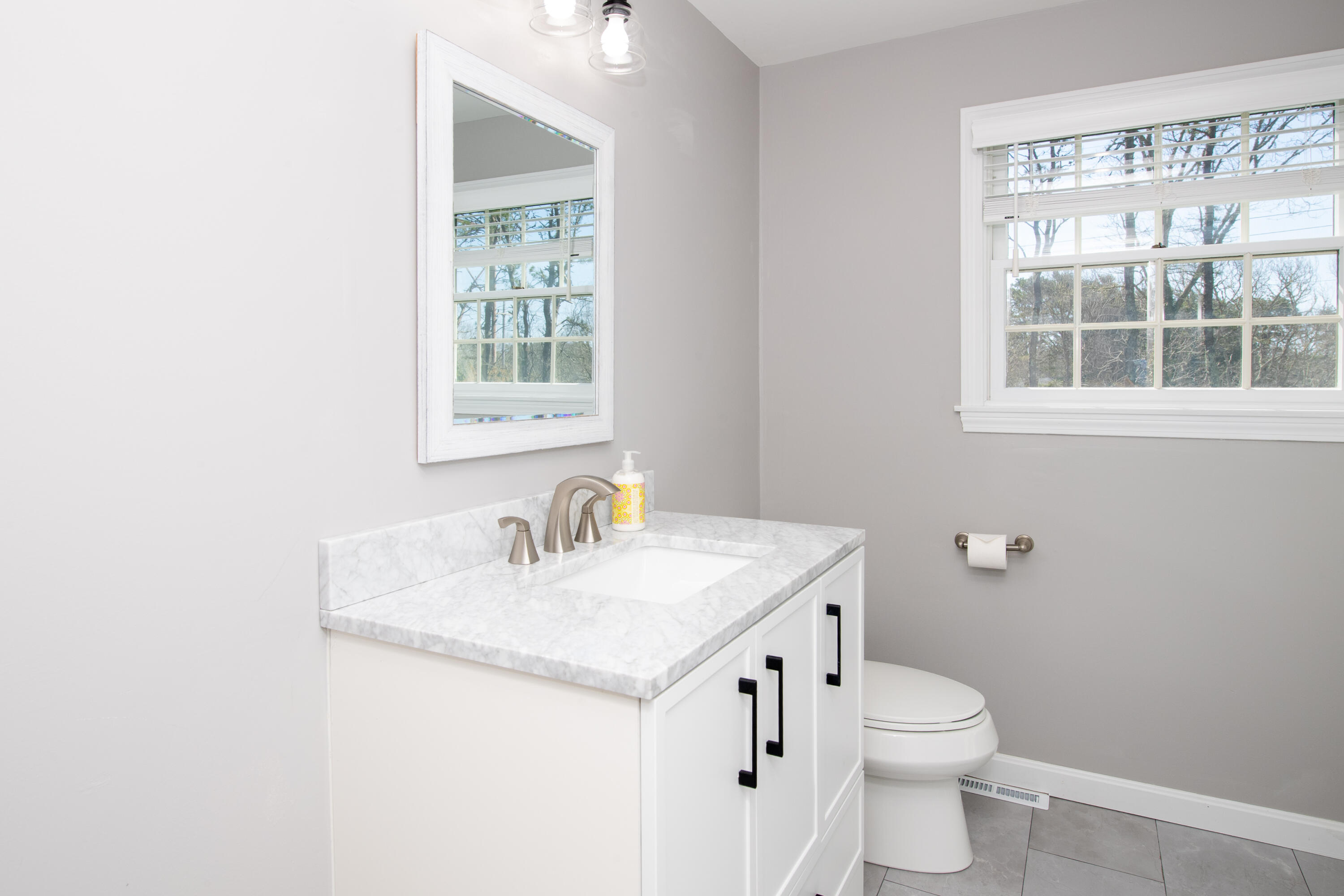 89 Trout Brook Road Cotuit, MA 02635 - Photo 34 of 67 a bathroom with a sink a toilet and a window