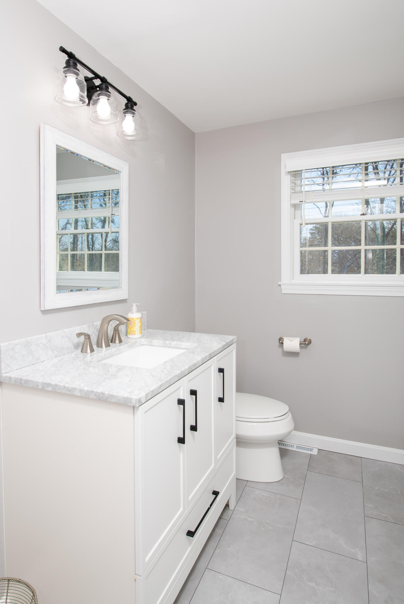 89 Trout Brook Road Cotuit, MA 02635 - Photo 35 of 67 a bathroom with a granite countertop sink and a toilet