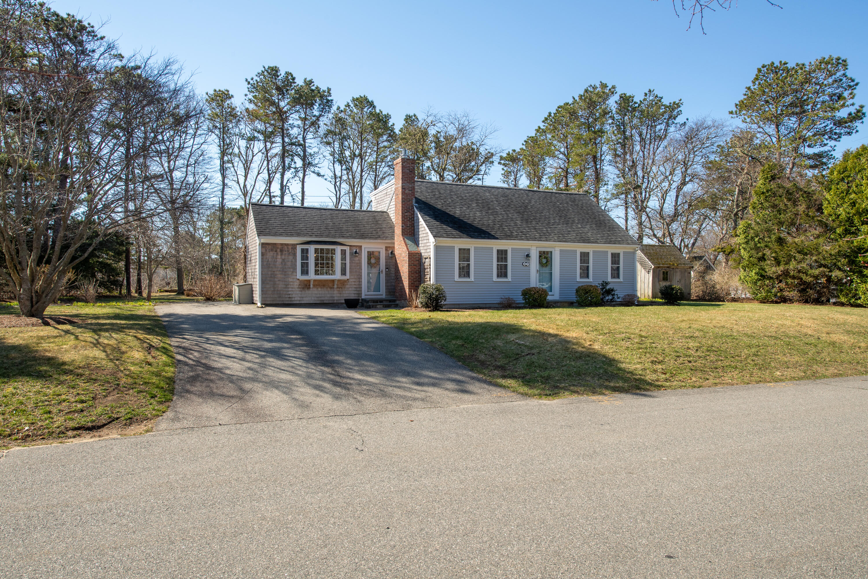 89 Trout Brook Road Cotuit, MA 02635 - Photo 42 of 67 a view of large house with a big yard and large trees
