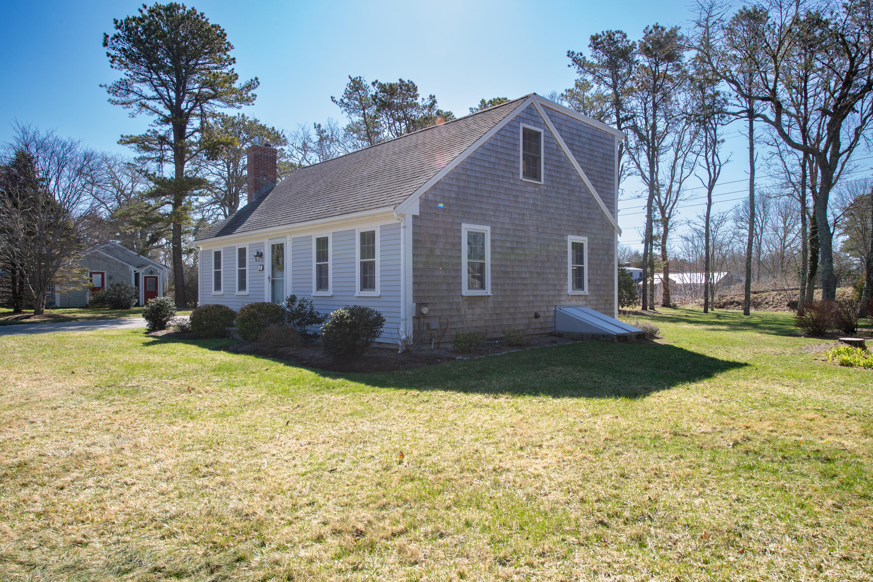 89 Trout Brook Road Cotuit, MA 02635 - Photo 48 of 67 a view of a house with a yard