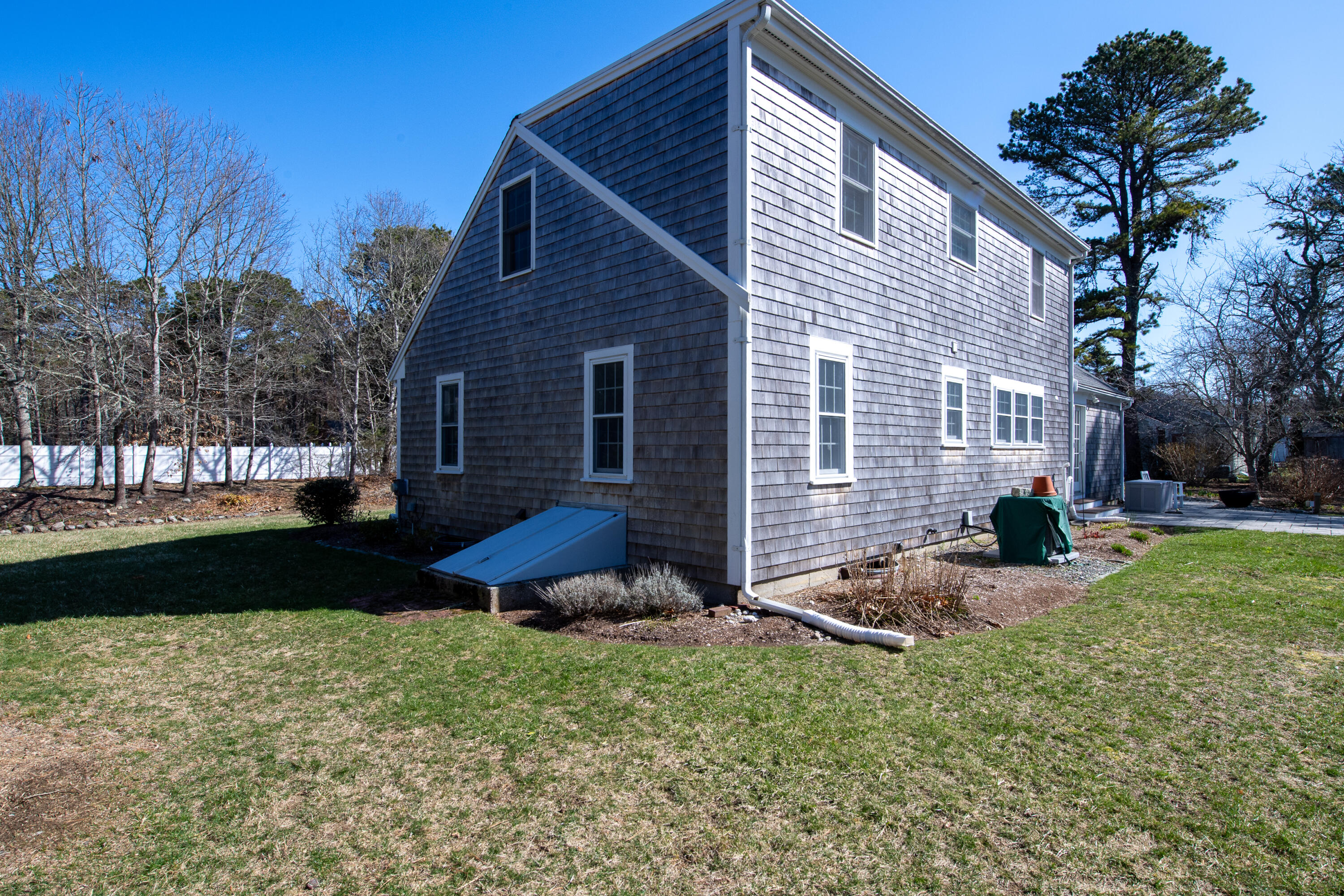 89 Trout Brook Road Cotuit, MA 02635 - Photo 50 of 67 a backyard of a house with table and chairs