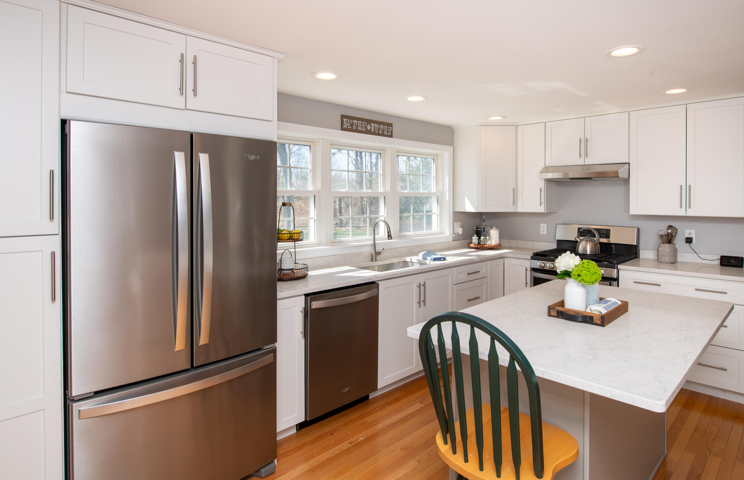 89 Trout Brook Road Cotuit, MA 02635 - Photo 6 of 67 a kitchen with stainless steel appliances granite countertop a refrigerator a sink a stove a table and chairs