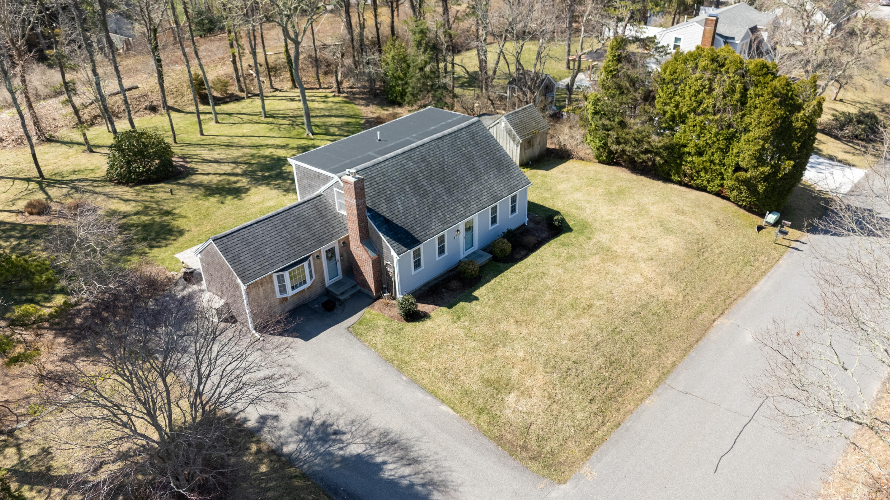 89 Trout Brook Road Cotuit, MA 02635 - Photo 62 of 67 a view of a yard with wooden fence