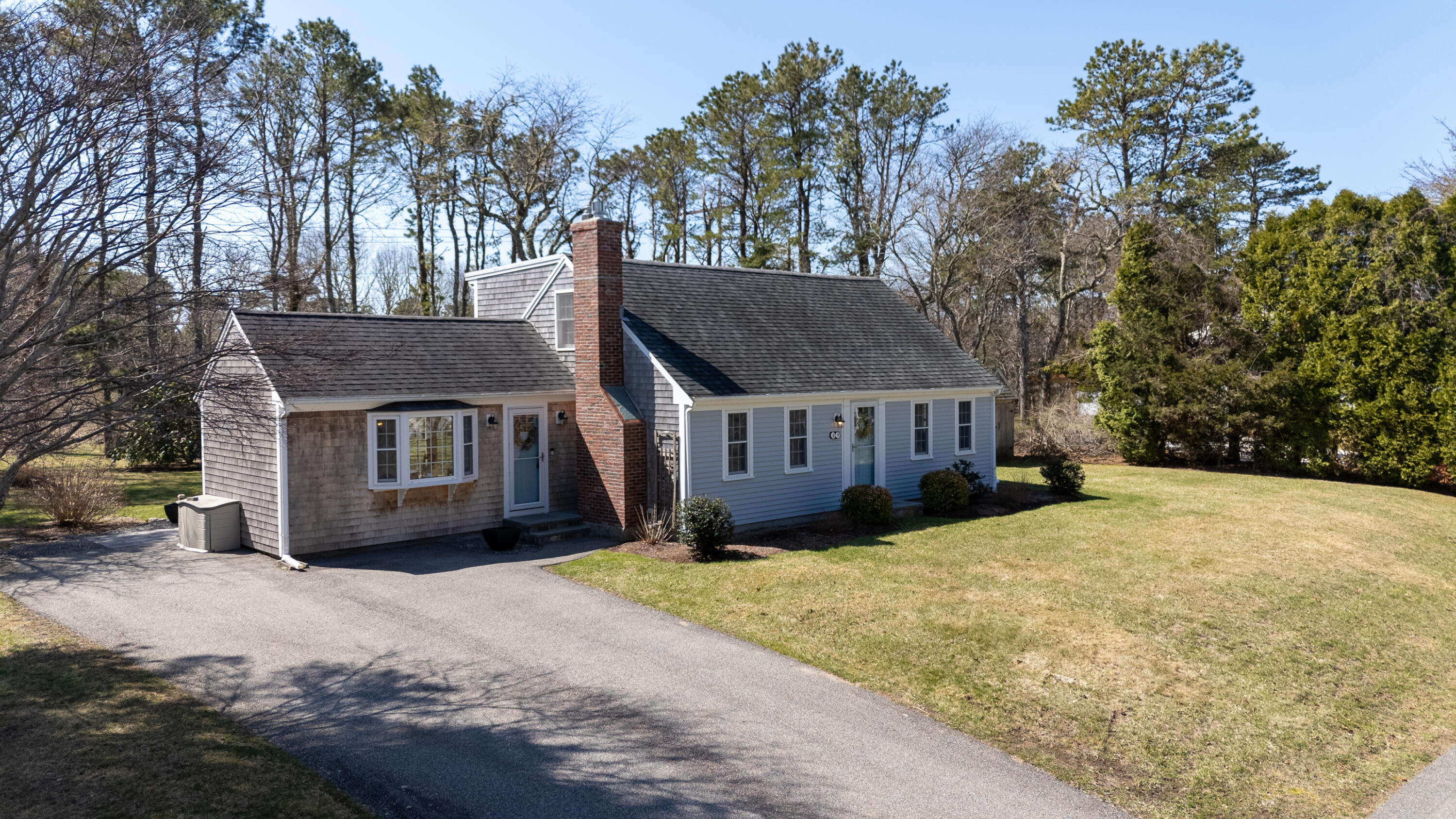 89 Trout Brook Road Cotuit, MA 02635 - Photo 66 of 67 a view of a house with a yard covered in snow