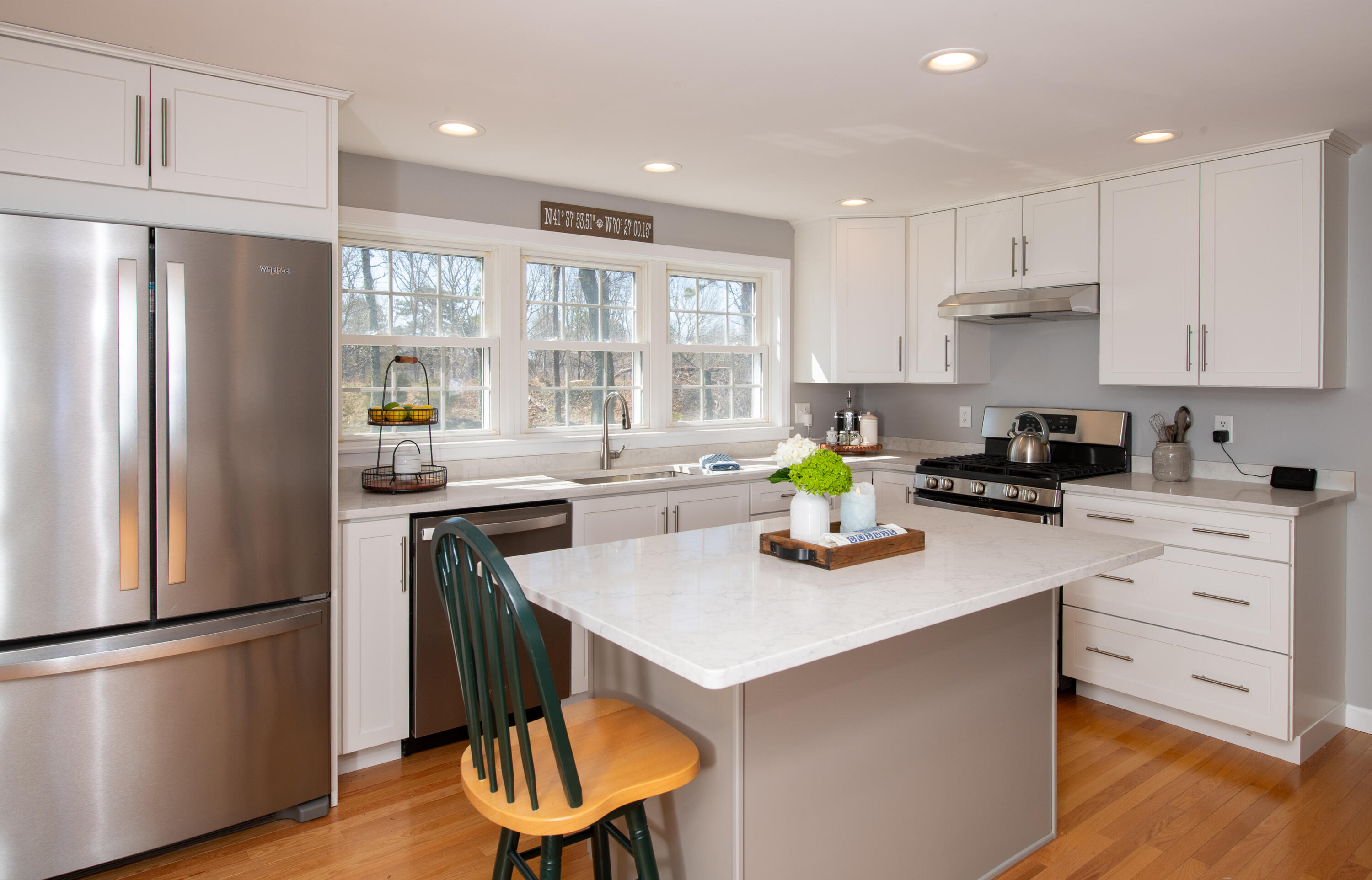 89 Trout Brook Road Cotuit, MA 02635 - Photo 9 of 67 a kitchen with stainless steel appliances a refrigerator a stove a sink cabinets and a dining table