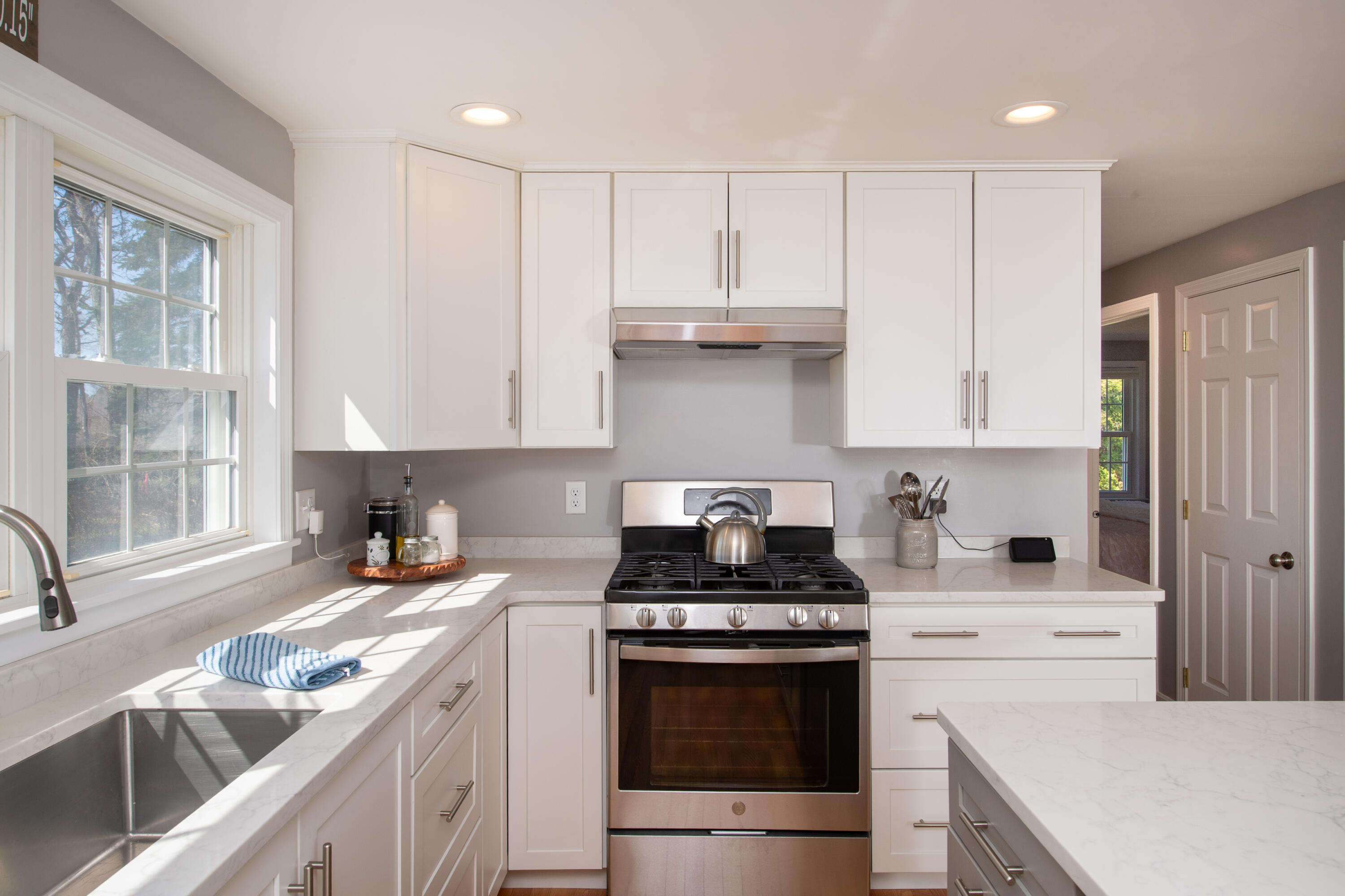 89 Trout Brook Road Cotuit, MA 02635 - Photo 10 of 67 a kitchen with granite countertop a sink a stove and cabinets