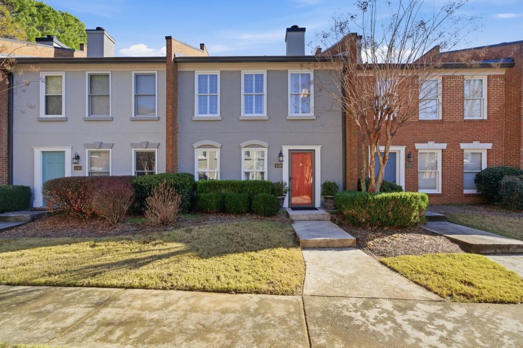 4138 Crape Myrtle Lane Duluth, GA 30096 - Photo 14 of 50 a view of a brick house with plants and many windows